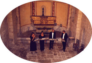 The quartet singing a concert of sacred music in a small medieval church on top of a mountian in Provence, France.